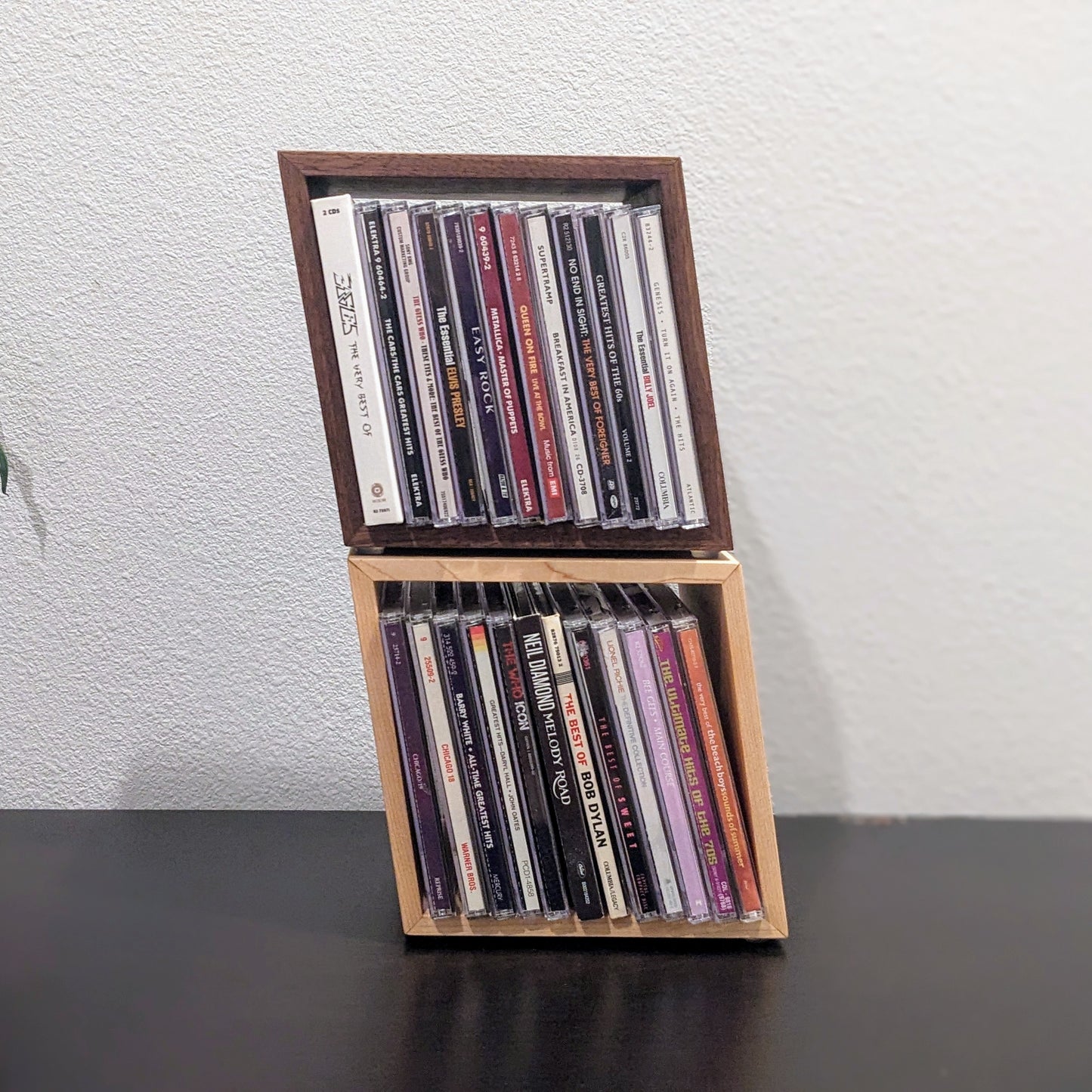 Wooden CD holder with CDs on a plain background