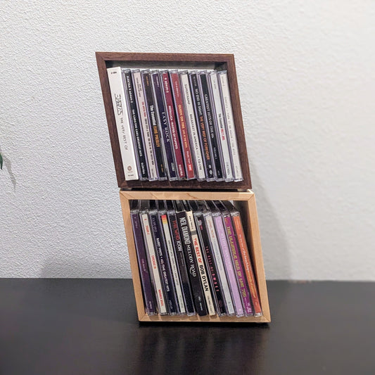 Wooden CD holder with CDs on a plain background